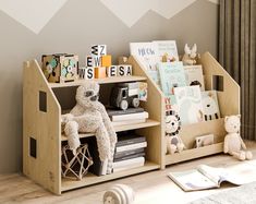 a child's book shelf with books and stuffed animals on it in a room