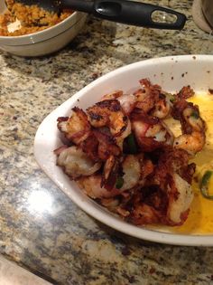 a white bowl filled with food on top of a counter