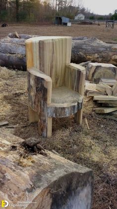 a chair made out of wood sitting on top of a pile of tree stumps