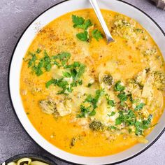 a bowl of soup with broccoli and cheese