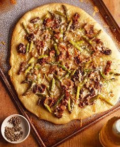 a pizza sitting on top of a pan covered in toppings