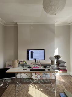 a computer monitor sitting on top of a desk next to a keyboard and mouse pad