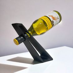 a wine bottle holder with a corkscrew on it