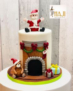 a santa clause sitting on top of a white cake