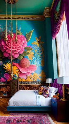 a bedroom decorated in blue, pink and yellow with flowers painted on the wall above the bed