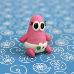 a pink toy sitting on top of a blue table