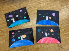 three pieces of paper are on the floor with space and planets painted on them,