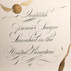 an ornate calligraphy is displayed on a white card with gold accents and a tassel