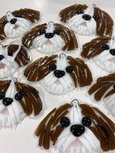 some brown and white cupcakes with chocolate icing in the shape of a dog's face