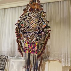 an elaborately decorated clock hanging from the ceiling