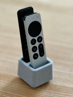 a remote control in a holder on a table