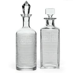 two clear glass bottles sitting next to each other