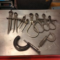 there are many different types of tools on the table with it's handles and wrenches