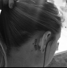 a woman with a tattoo on her left ear