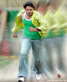 a man in green shirt and jeans running