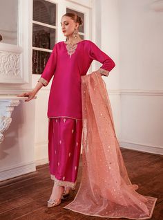 Elevate your style with this intriguing and elegant hot pink silhouette. The ensemble features exquisite embroidered details on the neckline, sleeves and bottom with shade of pink, adding a touch of sophistication and charm. Paired with a contrast organza dupatta, this outfit effortlessly enhances your look, making it perfect for any occasion where you want to make a stylish and memorable impression. Shirt: Raw SilkPants: Raw SilkDupatta: Organza Celebration Shirt, Zainab Chottani, Vibrant Gradient, Indian Designer Suits, Desi Wear, Chiffon Collection, Eid Collection, Organza Dupatta, Pakistani Designers