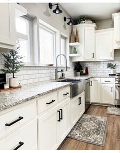 the kitchen is clean and ready to be used for cooking or baking, with all white cabinetry