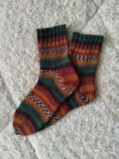 These handcrafted wool socks are made from a high-quality blend of 75% wool and 25% acrylic, ensuring they are both soft and durable. With a beautiful striped socks design in earthy tones such as green, burgundy, mustard, and brown, these cozy socks are perfect for keeping your feet warm on chilly days. Available in sizes from XS to XXL, these unisex socks are designed for a perfect fit, making them suitable for everyone. These warm socks are a great addition to your wardrobe and are ideal for both casual wear and special occasions. Whether you're searching for gift socks for Christmas, birthdays, or other holidays, these handmade socks make a thoughtful and unique present for friends and family. Their vibrant colors and soft texture make them the perfect winter socks, offering style and c Grandpa Clothes, Woolen Socks, Socks Design, Cozy Clothes, Handmade Socks, Unique Socks, Sixth Form, Knitted Items, Sock Knitting