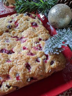 a close up of food on a plate near a christmas tree