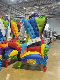 two colorful chairs sitting side by side in a warehouse