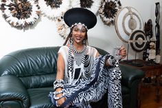 This elegant Zulu Basket Hat in black with beading is the perfect accessory to upgrade any outfit. This piece is handmade by female artisans in South Africa. The hat is made out of woven grass, polyester cloth patterned with cotton, wool threads, and decorative glass beads. It can be worn on special occasions like birthdays, weddings, and formal gatherings. As with all handmade items, no two pieces are the same. PRODUCT DESCRIPTION: 15" W × 7" H Head Size: 24" Basket Hat, South African Traditional Dresses, Wool Thread, African Traditional Dresses, Decorative Glass, Zulu, Cotton Wool, Women Artisans, Traditional Dresses