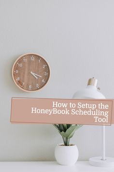 a clock on top of a desk with the words how to setup the honey book schedule tool