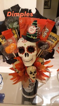 a skull with candy and candies in it's mouth sitting on a table