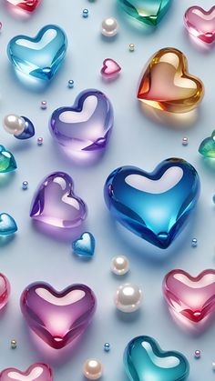 many different colored hearts and pearls on a white surface