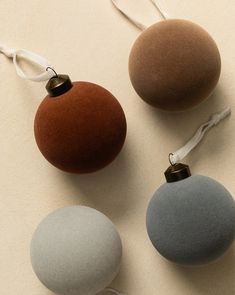 three different colored balls with white string attached to them