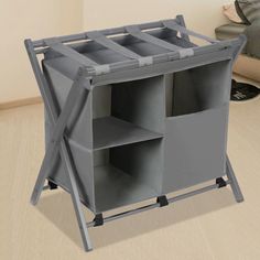 a grey folding storage unit with four bins on each side and three shelves in the middle