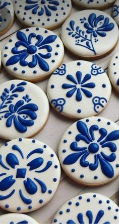 blue and white decorated cookies sitting on top of a table