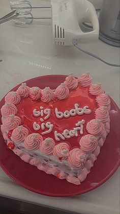 a heart shaped cake sitting on top of a red plate