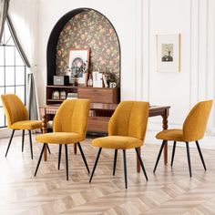 four yellow chairs sitting in front of a wooden table