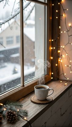 a cup of coffee sitting on top of a window sill