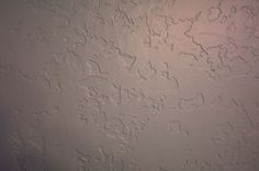 the wall is covered in white paint and has many small scratches on it's surface