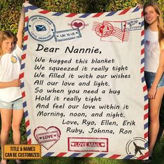 two girls standing next to a sign that reads dear nannie, we hugged this blanket