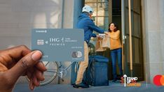 a person holding up a credit card in front of a man on a bicycle and another woman standing next to the door