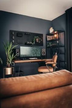 a brown leather couch sitting in front of a computer desk