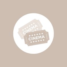 two movie tickets sitting on top of each other in front of a white circle with the words cinema written across it