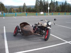 a motorcycle with a sidecar parked in a parking lot