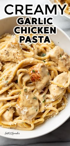 creamy garlic chicken pasta in a white bowl with parmesan cheese on the side