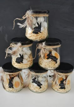 a stack of jars filled with eggs on top of a table