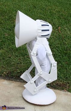 a white lamp sitting on top of a sidewalk