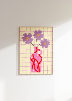 a pink vase with purple flowers is hanging on the wall