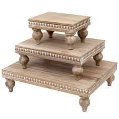 three tiered wooden trays with carved designs on the top and bottom, set against a white background