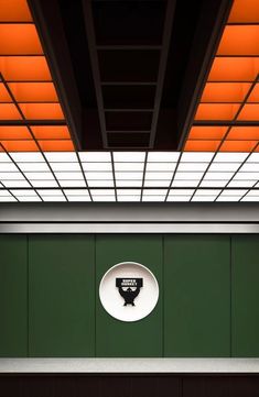 a green wall with an orange and white ceiling