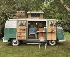 an old camper van is parked in the grass