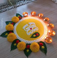 a decorated diya with candles on the floor