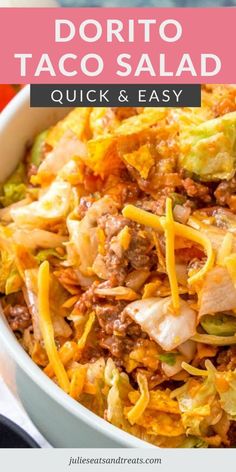 a white bowl filled with taco salad next to a red napkin and fork on the side