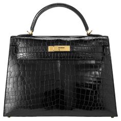 Hermès Kelly Sellier 32 in noir and niloticus crocodile leather with gold hardware. The bag has been worn but still in very good condition: small scratches on the hardware, small spots on front and back of the bag and small marks inside the bag. Comes as full set including Cites. Stamp D (2019) Birkin Mom, Kelly 32, Kelly Sellier, Hermes Kelly Bag, Sunglasses Logo, Jane Birkin, Shopping Photography, Crocodile Leather, Future Me